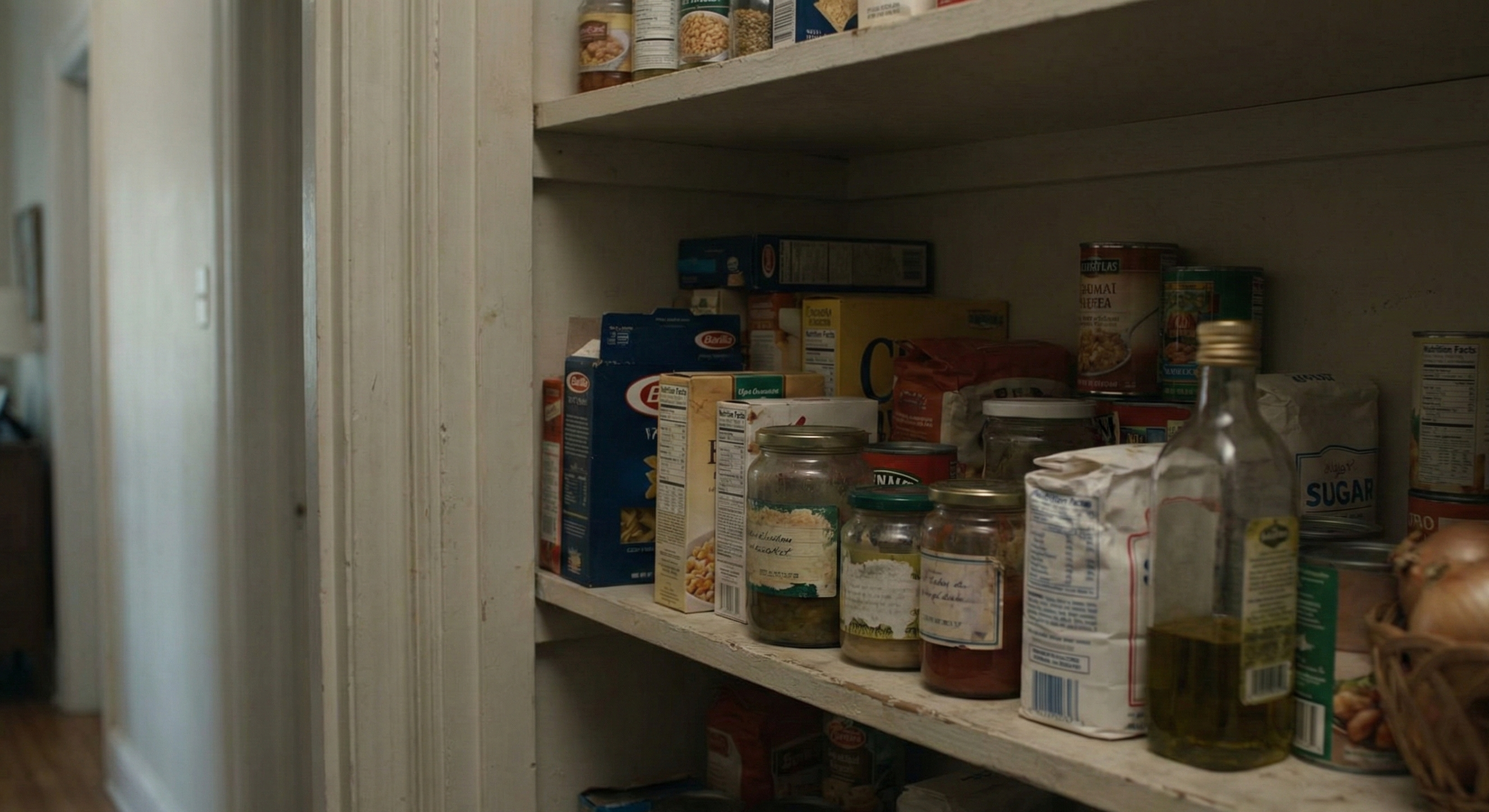 Pantry shelf stocked with various food items and supplies